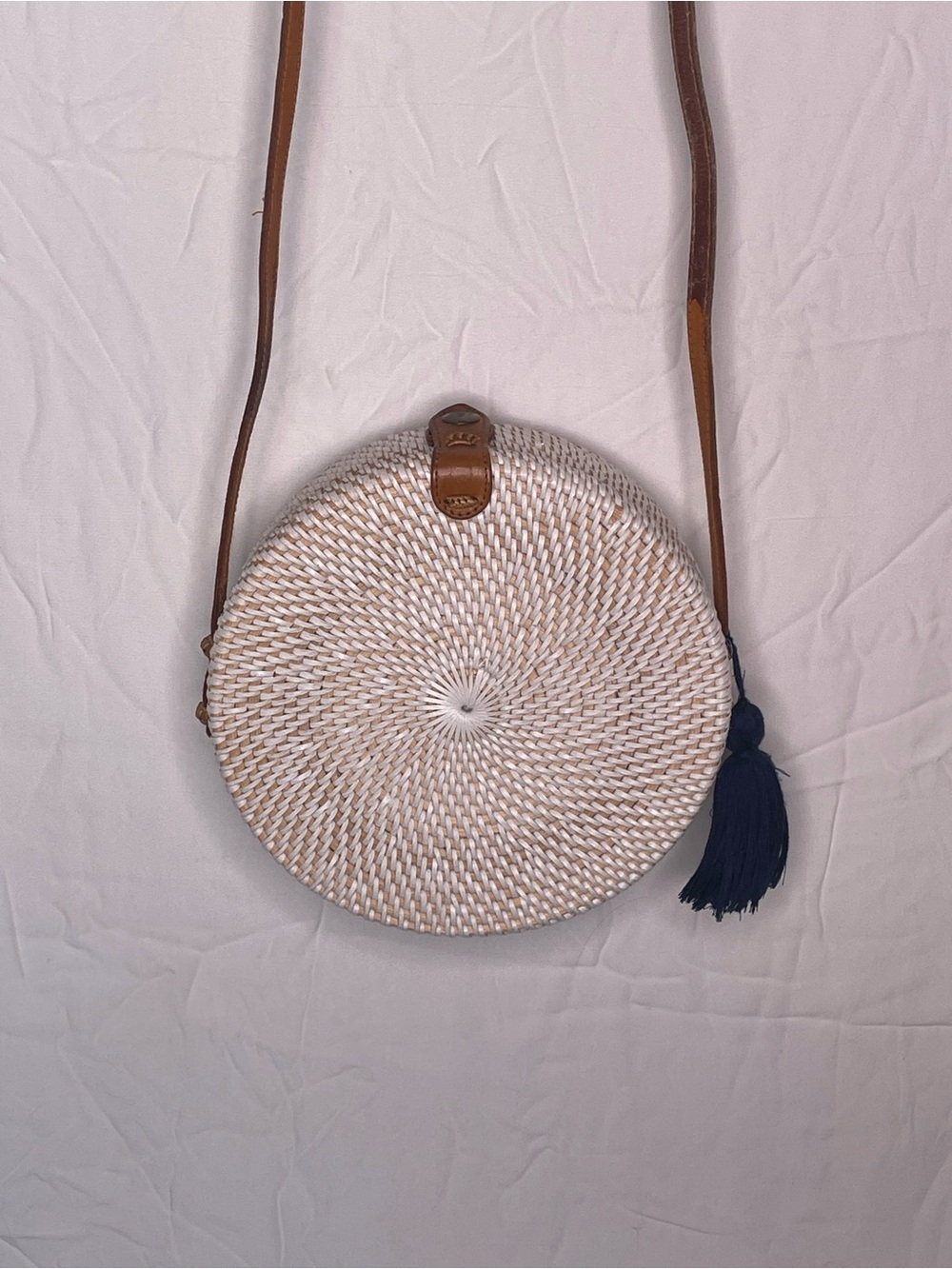crafted round rattan crossbody bag.